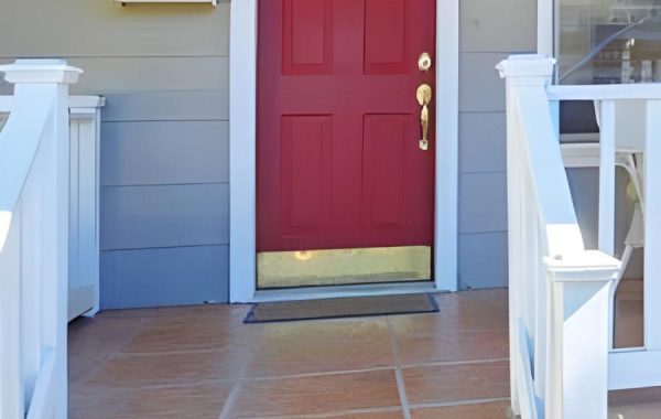 Red door with colored metal kick plate