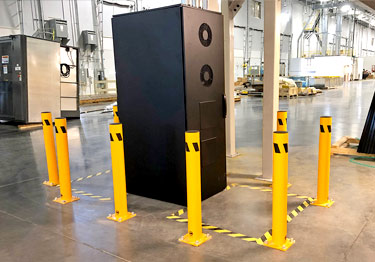 Steel bollard kit in high visibility yellow prevents damage from machinery