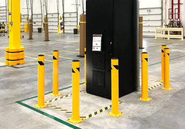 Steel bollard kit in high visibility yellow prevents damage from machinery