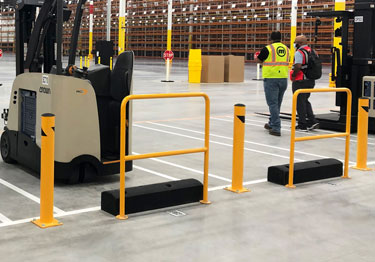 Steel bollard kit in high visibility yellow prevents damage from machinery