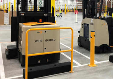 Steel bollard kit in high visibility yellow prevents damage from machinery