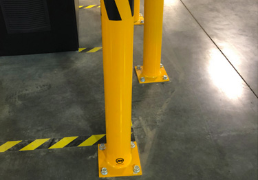 Steel bollard kit in high visibility yellow prevents damage from machinery